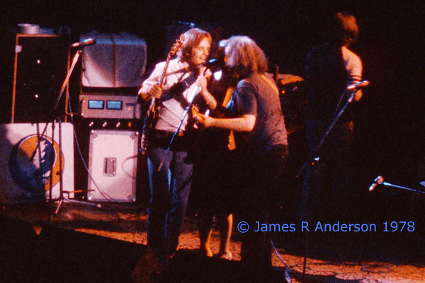 A rare photograph of Bobby Weir Donna and Jerry Garcia singing into one microphone. Photograph copyright James R Anderson